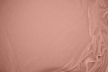 Arka plan olarak kullanılan gül sarısı kadife kumaş dokusu. Yumuşak ve pürüzsüz tekstil malzemelerinin sarı panne kumaş arka planı. Ezilmiş kadife. İpek için lüks altın rengi. Pembe altın.