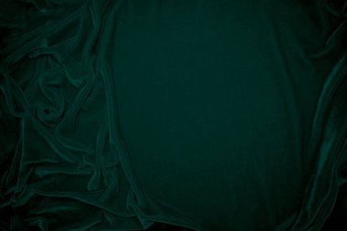 Green velvet fabric texture used as background. Peacock color panne fabric background of soft and smooth textile material. crushed velvet .luxury emerald tone for silk.	