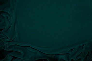 Green velvet fabric texture used as background. Peacock color panne fabric background of soft and smooth textile material. crushed velvet .luxury emerald tone for silk.	