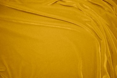 golden velvet fabric texture used as background. blond color panne fabric background of soft and smooth textile material. crushed velvet .luxury yellow tone for silk.	