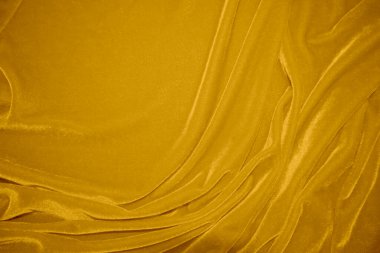 golden velvet fabric texture used as background. blond color panne fabric background of soft and smooth textile material. crushed velvet .luxury yellow tone for silk.	