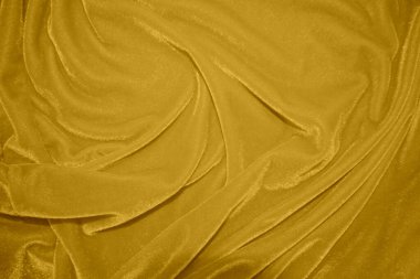 golden velvet fabric texture used as background. blond color panne fabric background of soft and smooth textile material. crushed velvet .luxury yellow tone for silk.	