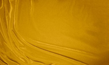 golden velvet fabric texture used as background. blond color panne fabric background of soft and smooth textile material. crushed velvet .luxury yellow tone for silk.	