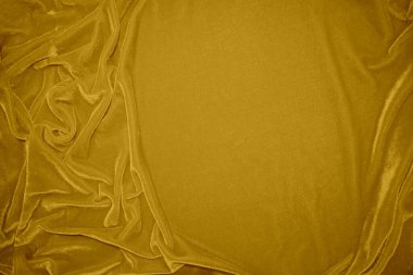 golden velvet fabric texture used as background. blond color panne fabric background of soft and smooth textile material. crushed velvet .luxury yellow tone for silk.	