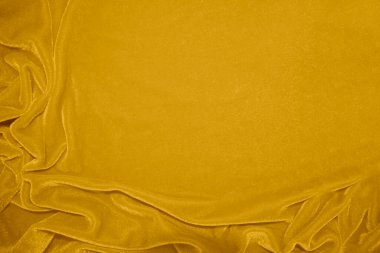 golden velvet fabric texture used as background. blond color panne fabric background of soft and smooth textile material. crushed velvet .luxury yellow tone for silk.	