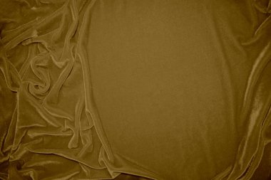 golden velvet fabric texture used as background. blond color panne fabric background of soft and light brown smooth textile material. crushed velvet .luxury yellow tone for silk.	