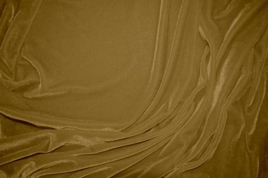 golden velvet fabric texture used as background. blond color panne fabric background of soft and light brown smooth textile material. crushed velvet .luxury yellow tone for silk.	