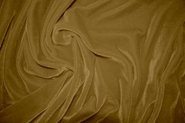 golden velvet fabric texture used as background. blond color panne fabric background of soft and light brown smooth textile material. crushed velvet .luxury yellow tone for silk.	