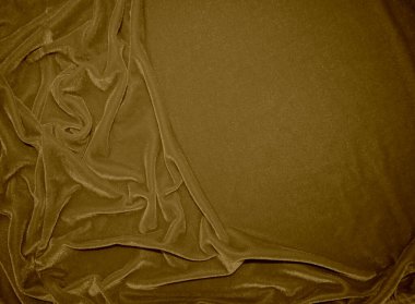 golden velvet fabric texture used as background. blond color panne fabric background of soft and light brown smooth textile material. crushed velvet .luxury yellow tone for silk.	