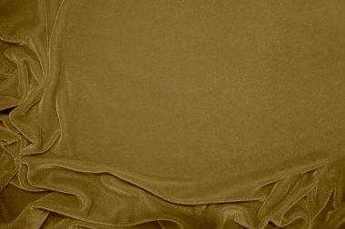 golden velvet fabric texture used as background. blond color panne fabric background of soft and light brown smooth textile material. crushed velvet .luxury yellow tone for silk.	
