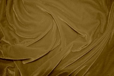 golden velvet fabric texture used as background. blond color panne fabric background of soft and light brown smooth textile material. crushed velvet .luxury yellow tone for silk.	