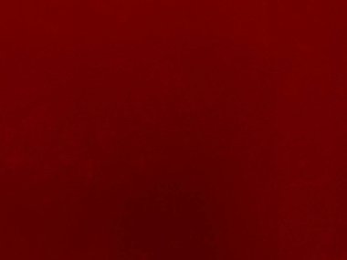 Arka plan olarak kırmızı kadife kumaş dokusu kullanılıyor. Yumuşak ve pürüzsüz tekstil malzemelerinin kırmızı paneli. Ezilmiş kadife. İpek için lüks kırmızı..