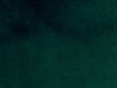 Green velvet fabric texture used as background. Emerald color panne fabric background of soft and smooth textile material. crushed velvet .luxury emerald tone for silk.	