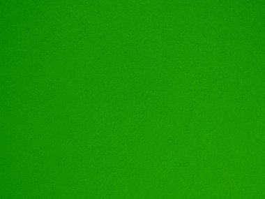 Felt green soft rough textile material background texture close up,poker table,tennis ball,table cloth. Empty green fabric denim background.