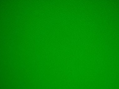 Felt green soft rough textile material background texture close up,poker table,tennis ball,table cloth. Empty green fabric denim background.