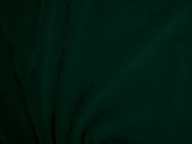 Green velvet fabric texture used as background. Emerald color panne fabric background of soft and smooth textile material. crushed velvet .luxury emerald tone for silk..	