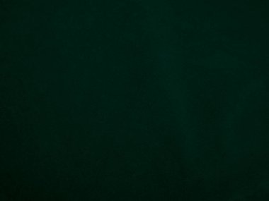 Green velvet fabric texture used as background. Emerald color panne fabric background of soft and smooth textile material. crushed velvet .luxury emerald tone for silk..	