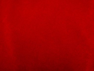 Arka plan olarak kırmızı kadife kumaş dokusu kullanılıyor. Yumuşak ve pürüzsüz tekstil malzemelerinin kırmızı paneli. Ezilmiş kadife. İpek için lüks kırmızı..