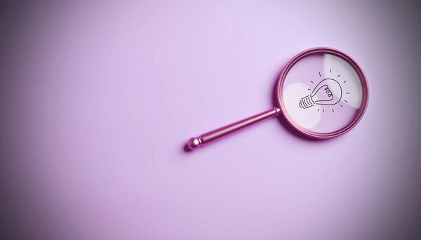 Light bulb inside of magnifier glass for focus business objective target search concept and success on pink background and copy space.