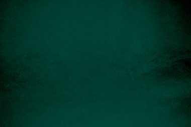 Green velvet fabric texture used as background. Emerald color panne fabric background of soft and smooth textile material. crushed velvet .luxury emerald tone for silk..	