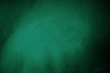 Green velvet fabric texture used as background. Emerald color panne fabric background of soft and smooth textile material. crushed velvet .luxury emerald tone for silk..	