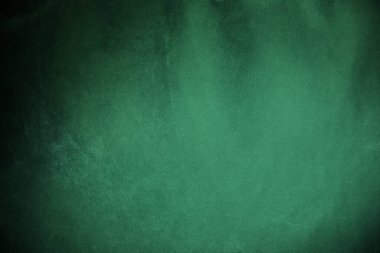 Green velvet fabric texture used as background. Emerald color panne fabric background of soft and smooth textile material. crushed velvet .luxury emerald tone for silk..	