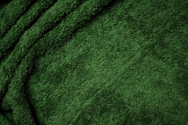 oil green velvet fabric texture used as background. Emerald color panne fabric background of soft and smooth textile material. crushed velvet .luxury emerald tone for silk.	