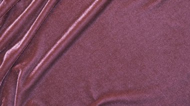 Arka plan olarak kullanılan pembe kadife kumaş dokusu. Yumuşak ve pürüzsüz tekstil malzemelerinden oluşan boş pembe kumaş arka plan lüksü. Metin için boşluk var.