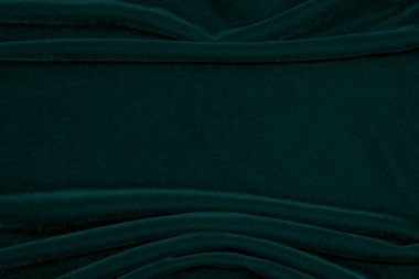 Green velvet fabric texture used as background. Empty green fabric background of soft and smooth textile material. There is space for text.	