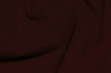 Arka plan olarak kullanılan koyu kırmızı kadife kumaş dokusu. Yumuşak ve pürüzsüz tekstil malzemelerinin ipek rengi kırmızı kumaş arka planı. Ezilmiş kadife. İpek için lüks koyu renk..