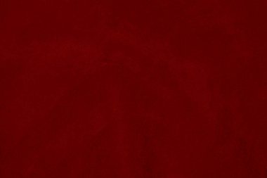 Arka plan olarak kullanılan koyu kırmızı kadife kumaş dokusu. Yumuşak ve pürüzsüz tekstil malzemelerinin ipek rengi kırmızı kumaş arka planı. Ezilmiş kadife. İpek için lüks koyu renk..