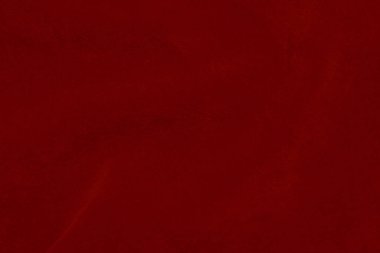 Arka plan olarak kullanılan koyu kırmızı kadife kumaş dokusu. Yumuşak ve pürüzsüz tekstil malzemelerinin ipek rengi kırmızı kumaş arka planı. Ezilmiş kadife. İpek için lüks koyu renk..