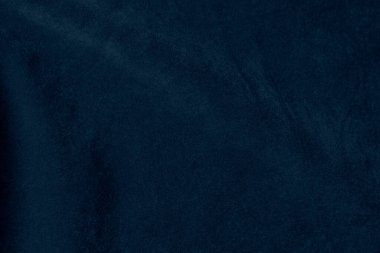 Arka plan olarak kullanılan koyu mavi kadife kumaş dokusu. Yumuşak ve pürüzsüz tekstil malzemelerinin ipek renkli kumaş arka planı. Ezilmiş kadife. Lüks lacivert ipeğin koyu tonu..