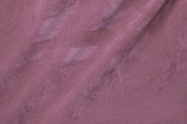 Arka plan olarak kullanılan açık pembe kadife kumaş dokusu. Yumuşak ve pürüzsüz tekstil malzemelerinin ipek rengi Sakura kumaş arka planı. Ezilmiş kadife. Lüks kiraz çiçeği. İpek için hafif ton..