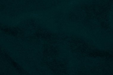 Arka plan olarak kullanılan koyu yeşil kadife kumaş dokusu. Yumuşak ve pürüzsüz tekstil malzemelerinin zümrüt renkli kumaş arka planı. Ezilmiş kadife. İpek için lüks zümrüt rengi....
