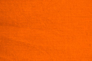 Arkaplan olarak kullanılan turuncu kadife kumaş dokusu. Yumuşak ve pürüzsüz tekstil malzemelerinden oluşan temiz kumaş. Kumaş, kadife, ipek için lüks turuncu güneş tonu..