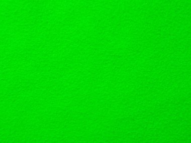 Yeşil bir arka plan ve desenli bir doku. Rengi parlak ve canlı. Taze ve canlı bir ortam izlenimi veriyor.