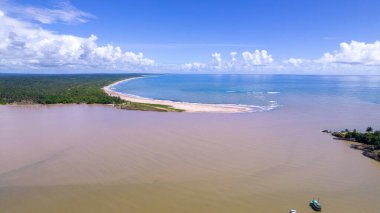 Aerial view of Itacare beach, Bahia, Brazil. Village with fishing boats and vegetation.