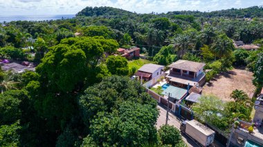 Aerial view of Itacare beach, Bahia, Brazil. Village with fishing boats and vegetation.