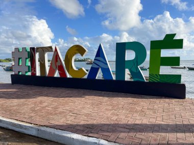 Itacare, Bahia, Bazil - 02, 2023; Itacare beach, Bahia, Brazil. Village with fishing boats and tourist sign with the writing of Itacare.