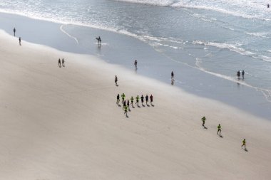 running on the sand at Praia da Pitangueiras in Guaruja, Sao Paulo. clipart