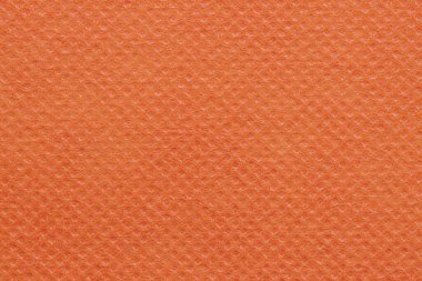 Orange non-woven polypropylene fabric texture. A piece of eco-friendly shopping bag material