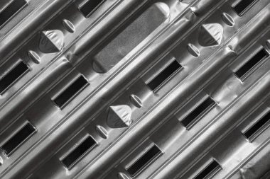 Barbecue pan with a ribbed texture and air slits. A fragment of the aluminum grill pan. Foil grill tray