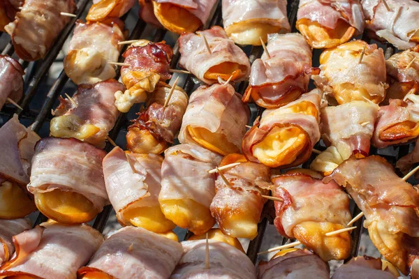 Smoked cheese made of salted sheep milk wrapped in bacon. Regional food product from the Tatra Mountains, Poland