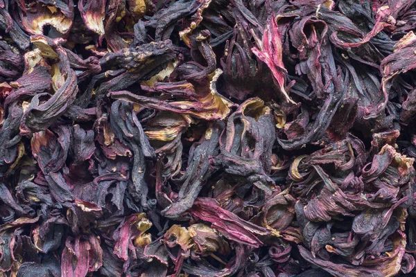 Dry hibiscus flower petals for aromatic tea. African food and drink background