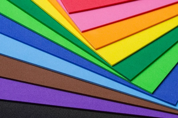 A mix of craft foam sheets in vibrant rainbow colors