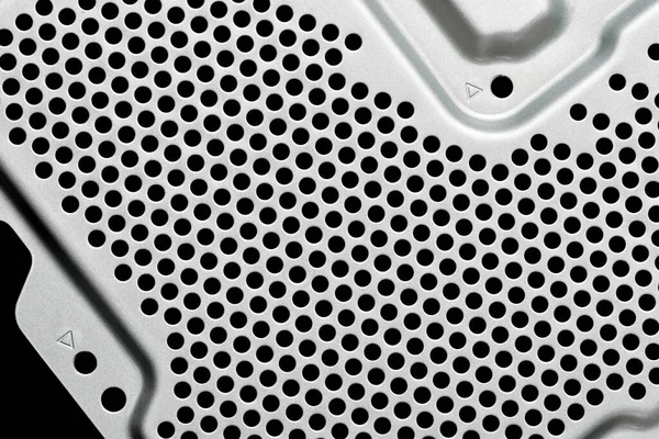 Perforated metal sheet with ventilation holes. Air cooling system of computer technology