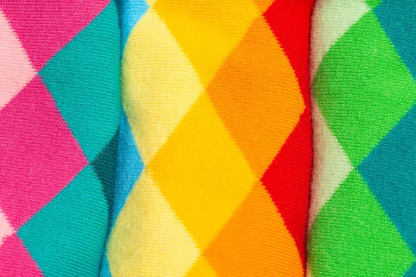 Argyle pattern on colorful socks. Diamond-shaped textiles as background