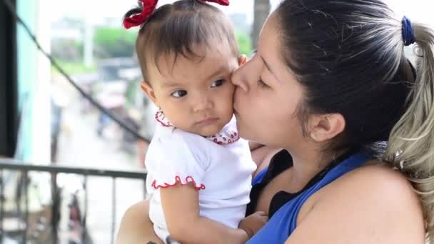 Latina Mother Holding Her Little Brunette Baby Girl While Giving — Vídeo de stock