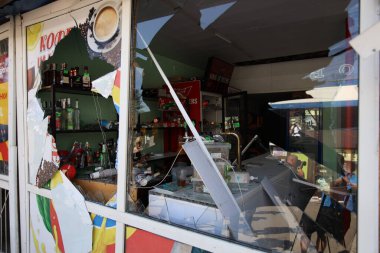 DNIPRO, UKRAINE - 08.24.20: bir Rus roketi Dnipro otobüs durağına çarptı. Otobüs durağı, dükkanlar ve ticaret kulübeleri yıkıldı. İşçiler hasarı temizler